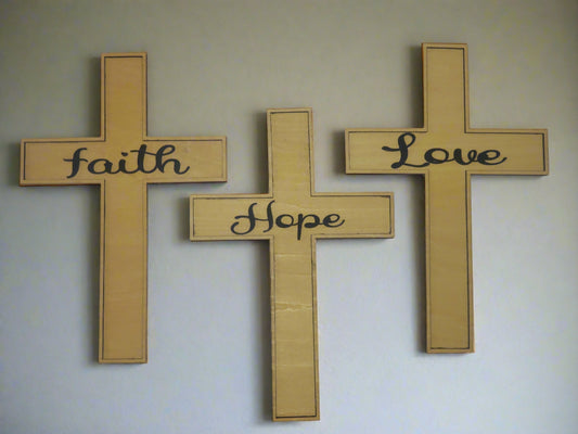 Wooden cross 3 piece set with 'Faith', 'Hope' and 'Love' written as a 3D layer attached to the center of the cross.