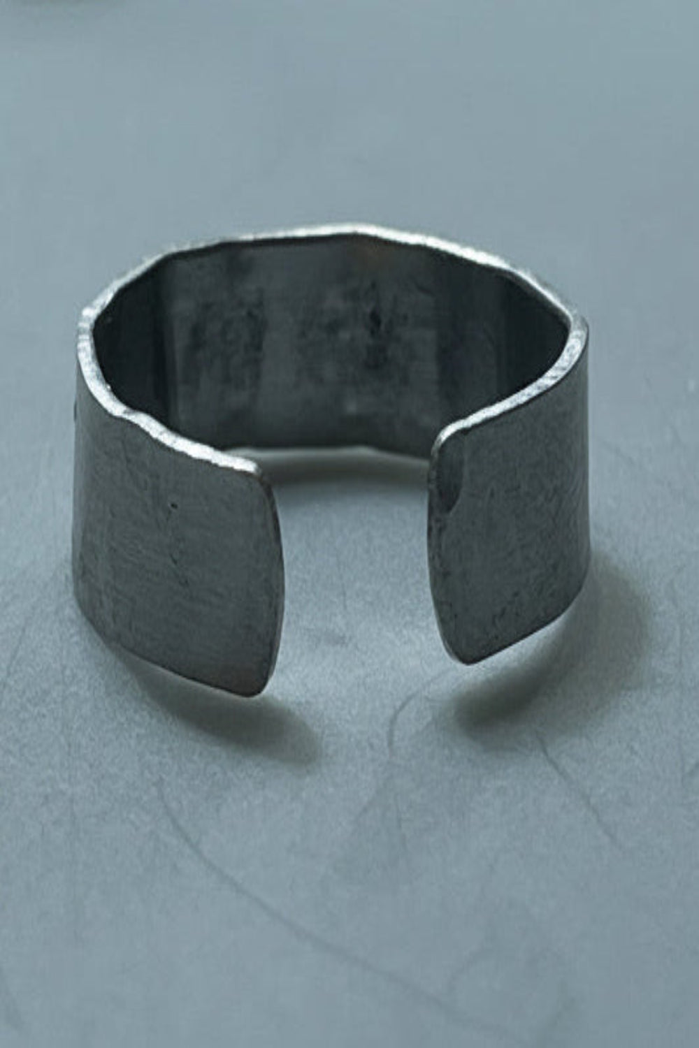 Silver color cuff ring on a gray background