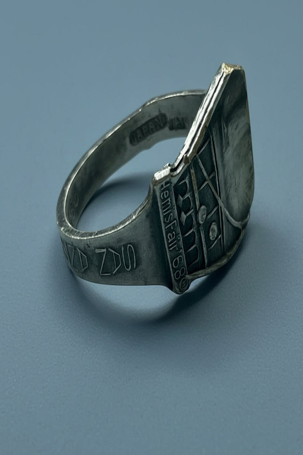Silver plated spoon ring with engraved design of the 1968 San Antonio Fair on a blue background.  This is upcycled and made from a collectable spoon of the event.