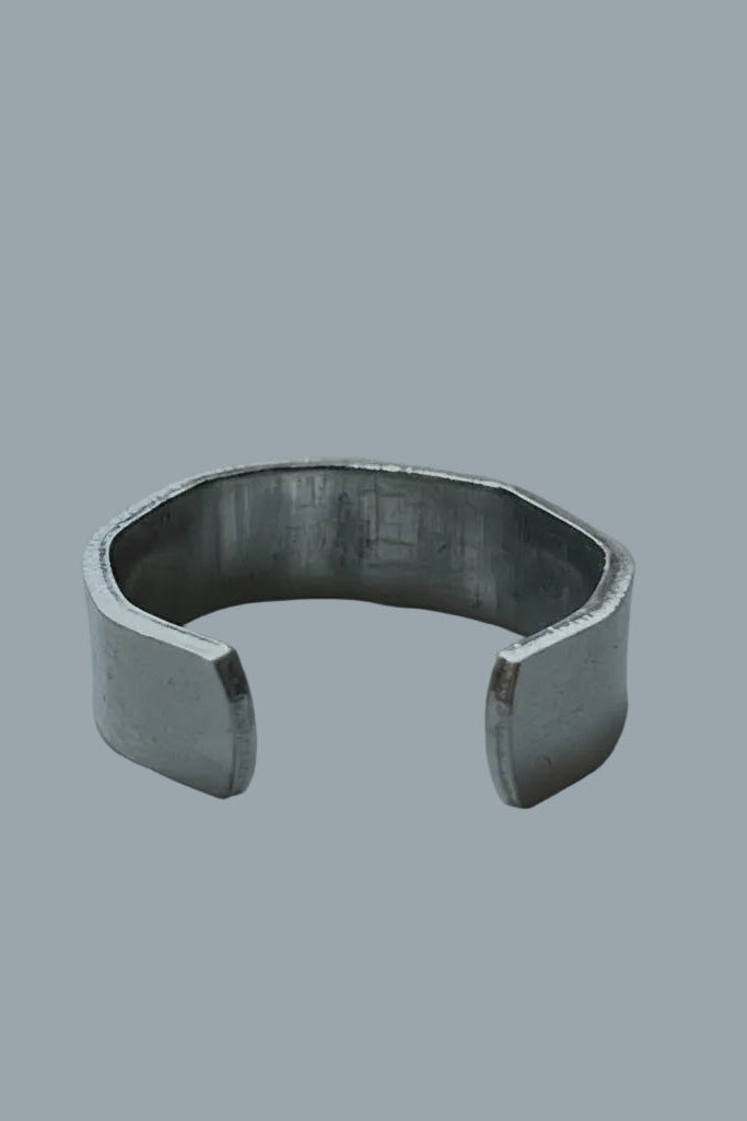 Silver color cuff ring on a gray background.