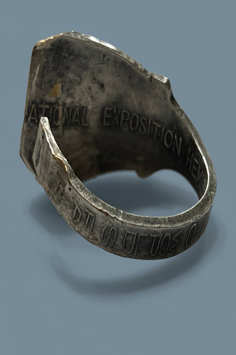 Silver plated spoon ring with engraved text of the San Antonio World's Fair in 1968 on a blue backgrounded 