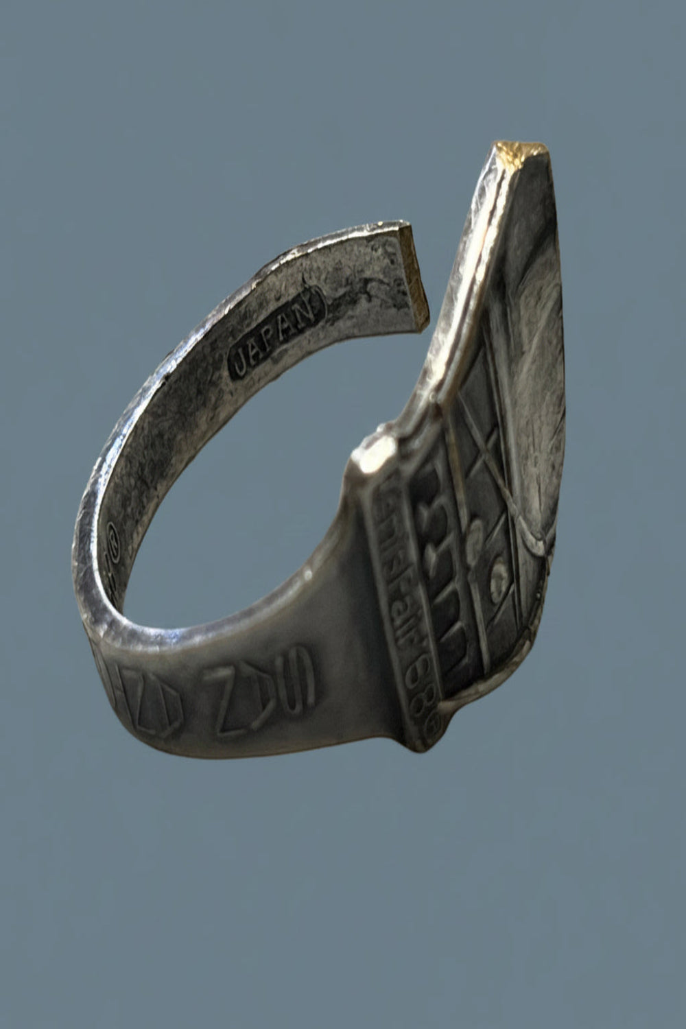 Silver plated spoon ring with engraved design of the 1968 San Antonio World's Fair on a gray background.  Original collectable spoon was made in Japan.  Spoon ring was handcrafted by Griff's Nest in Texas.