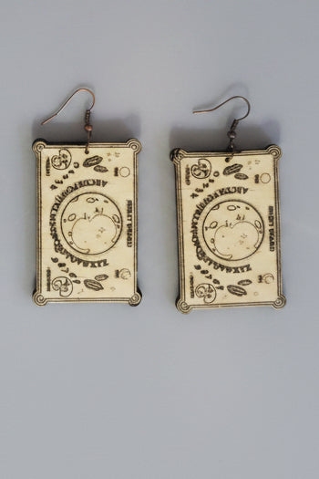 Pair of spirit board earrings with decorative designs.
