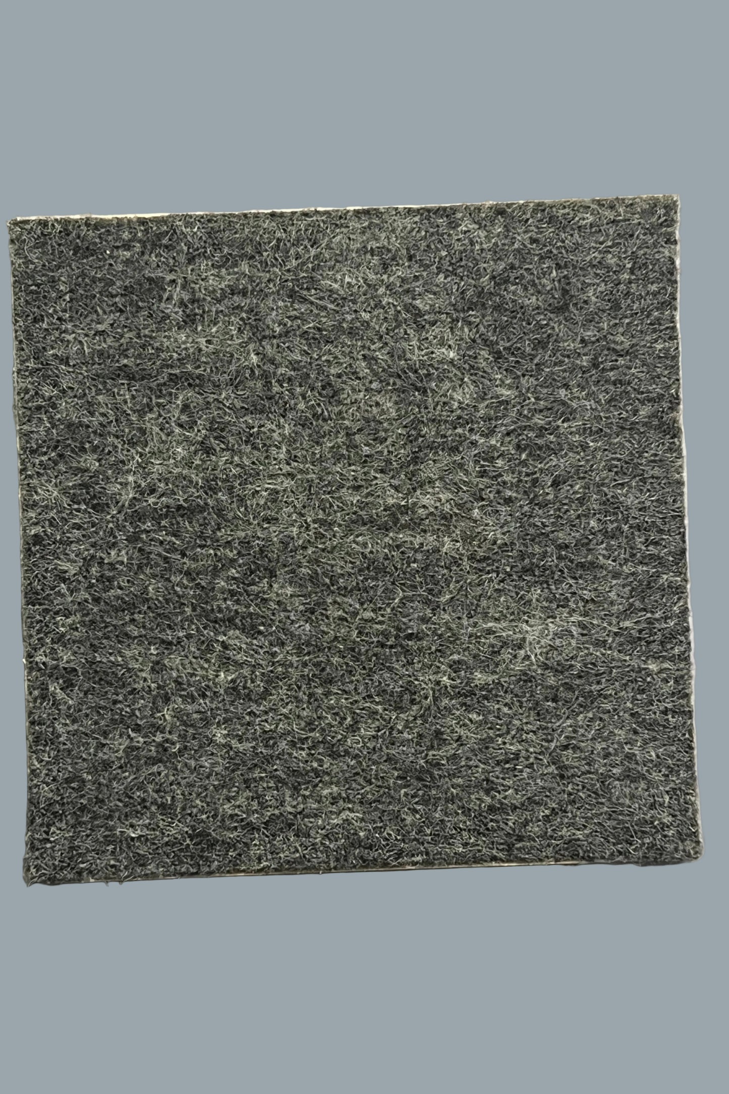 A dark gray felt with a textured, fibrous surface, shown as the reverse side of the ceramic plaque.  