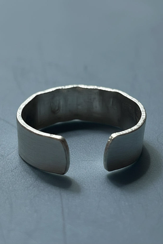 Silver color cuff ring on a gray background