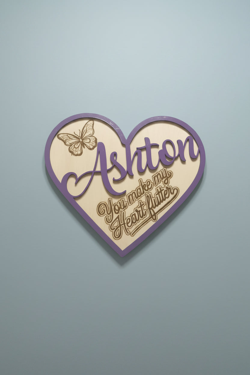 Personalized decorative heart-shaped cutout with a butterfly design burned into the wood with the saything 'you make my heart flutter'. 