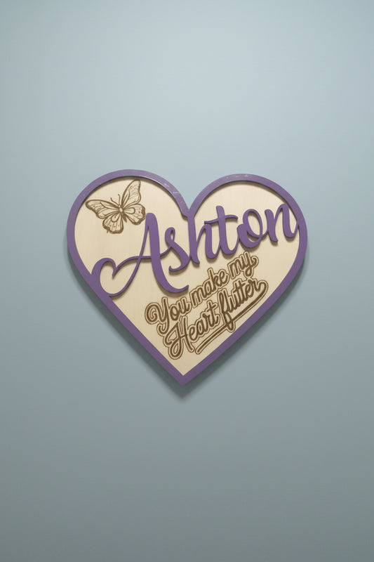 Personalized decorative heart-shaped cutout with a butterfly design burned into the wood with the saything 'you make my heart flutter'. 