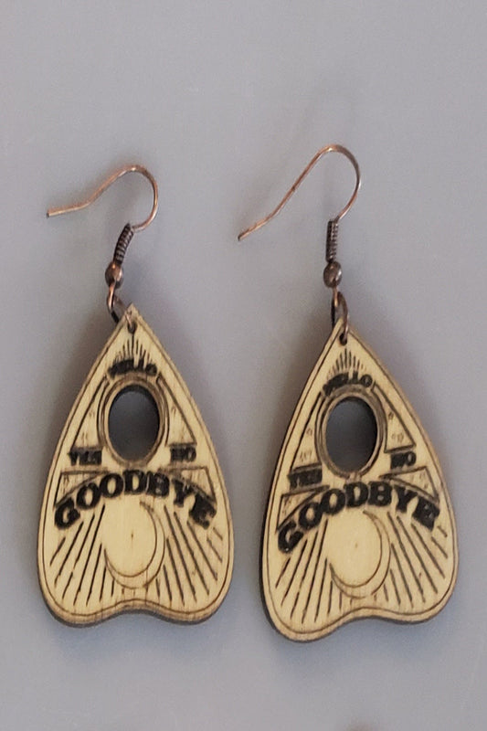 Planchette handle heart-shaped earrings with 'Goodbye' text etched into wood.