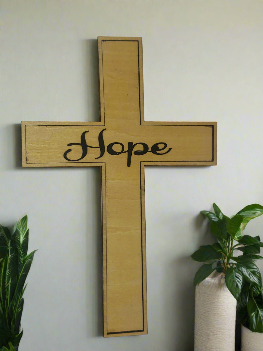 Wooden cross with 'Hope' written as a 3D layer attached to the center of the cross.