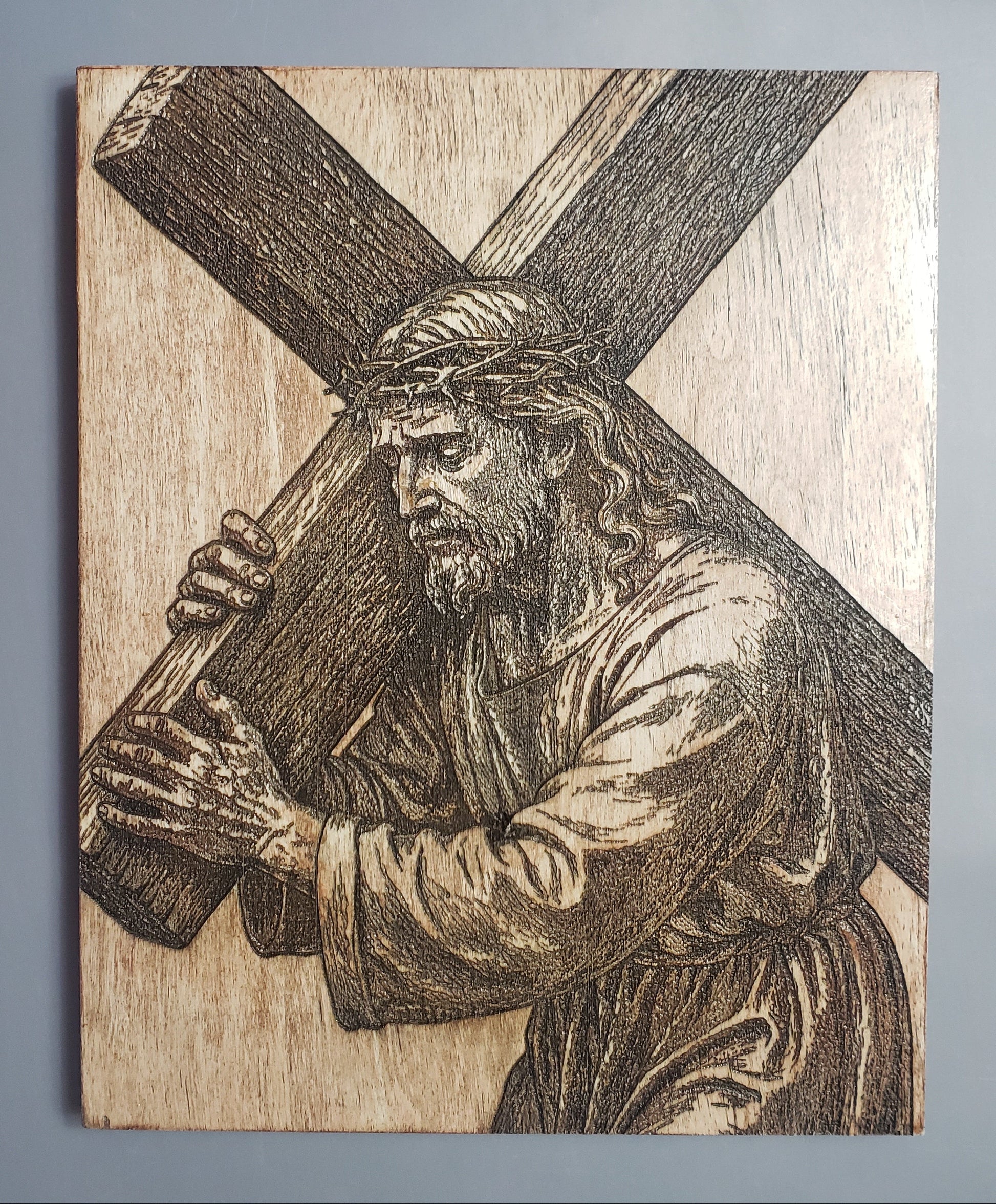 Wooden plague of Jesus carrying the cross