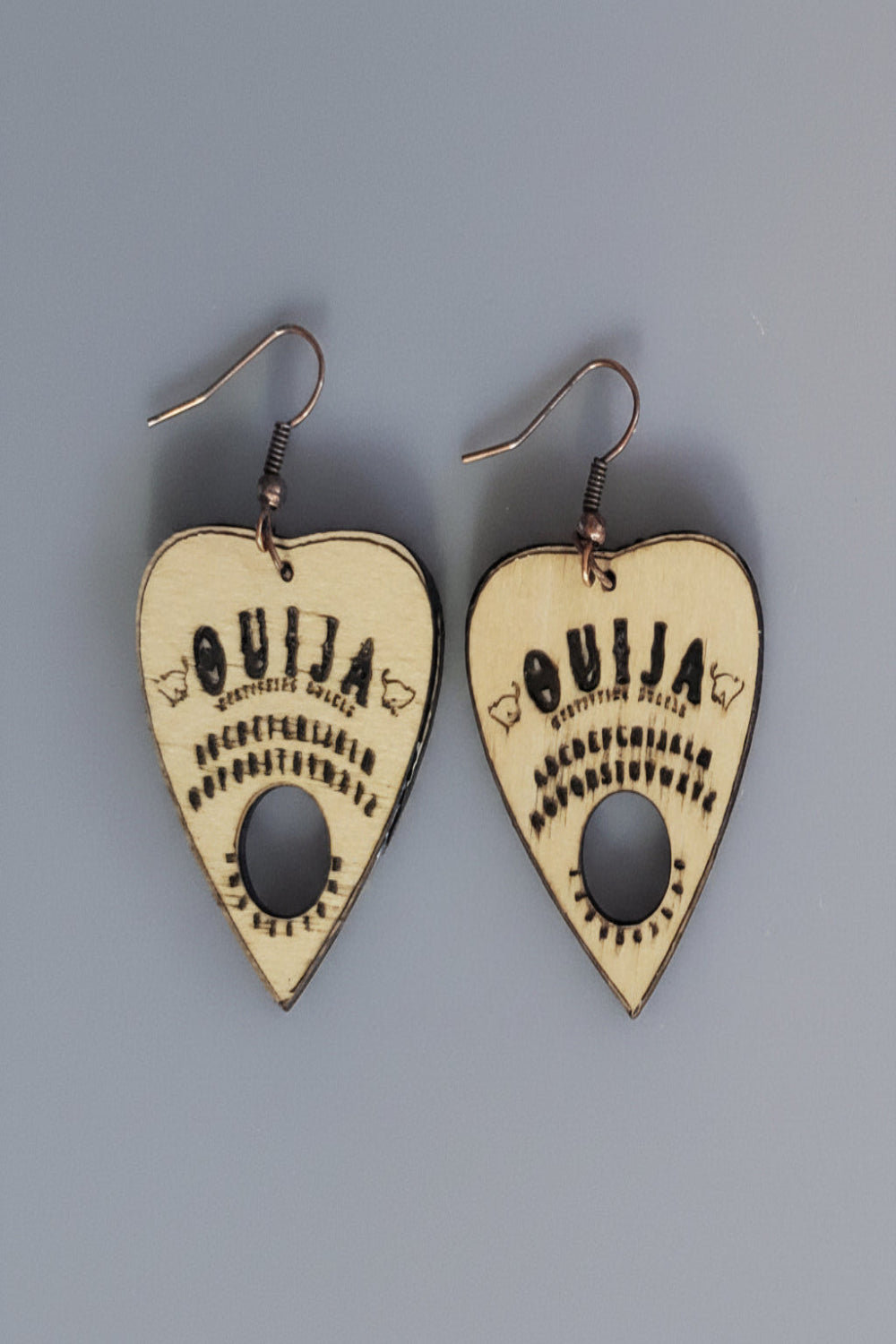 Ouija board inspired planchette handle earrings etched in wood