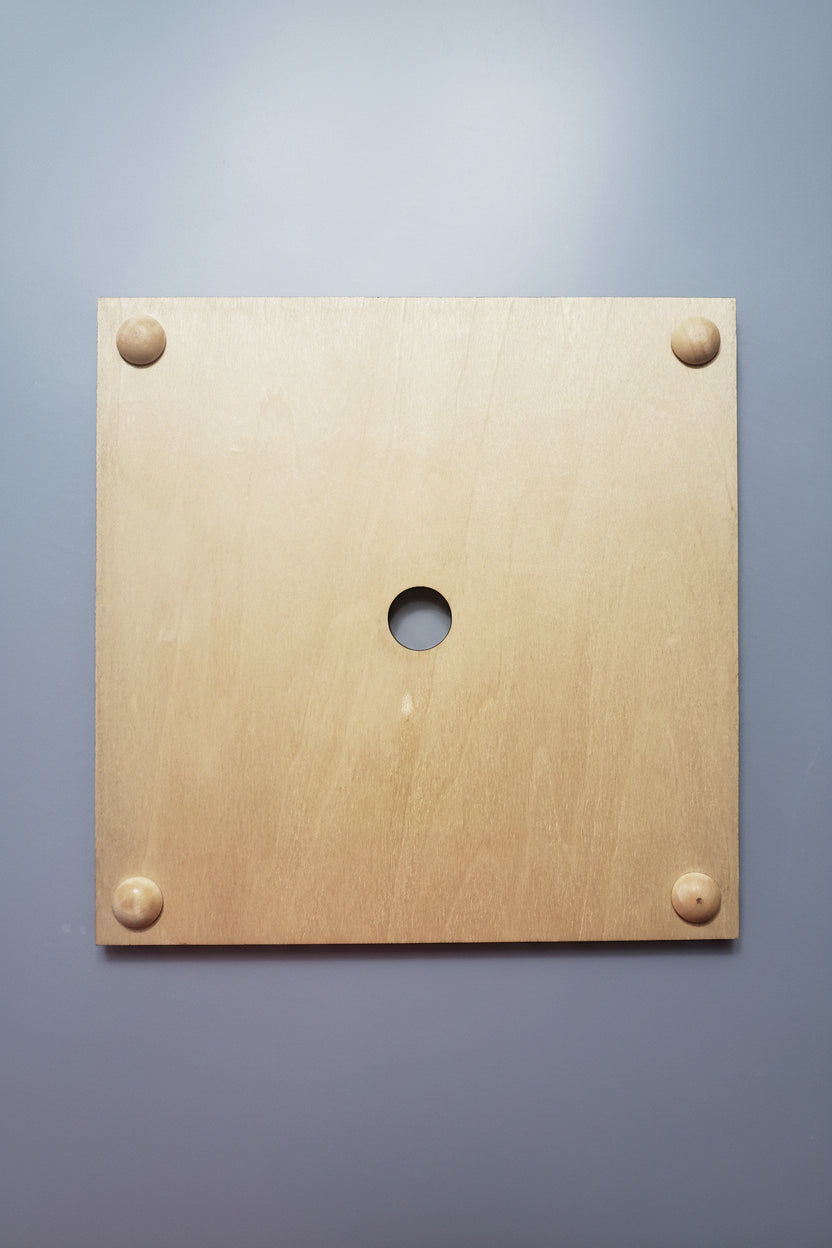 Under side view of trivet hot plate frame showing hole used to change the tile squares as desired for season, mood or decor. 