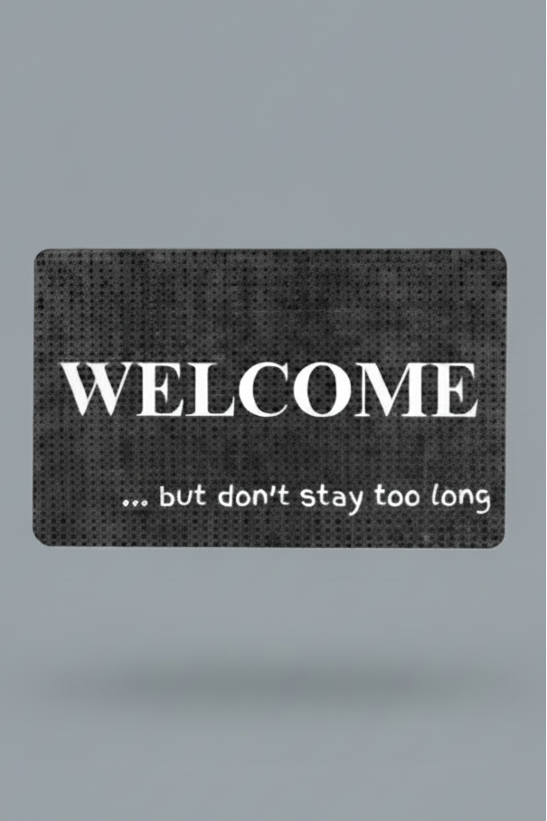 Black and gray doormat with white text 'WELCOME ... but don't stay too long'.  Order your custom phrase today.