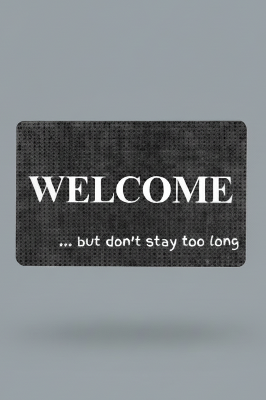 Black and gray doormat with white text 'WELCOME ... but don't stay too long'.  Order your custom phrase today.